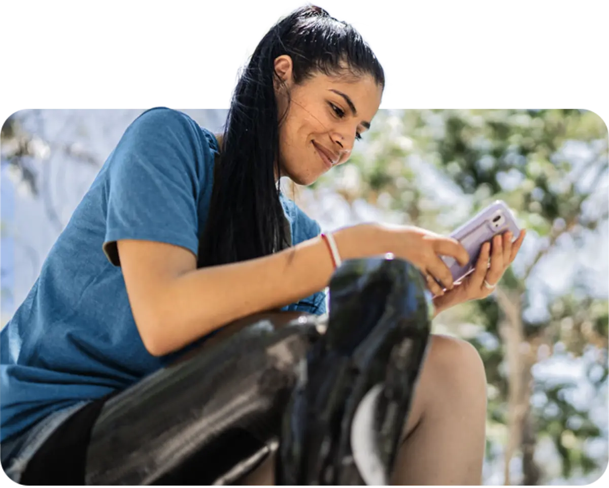Satisfied patient with prosthetic looking at phone