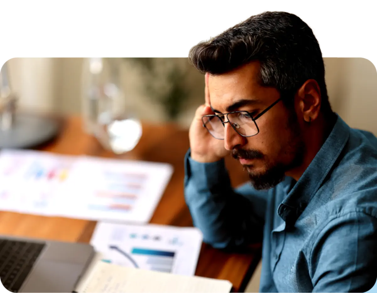 Man in glasses reviewing healthcare claim documentation