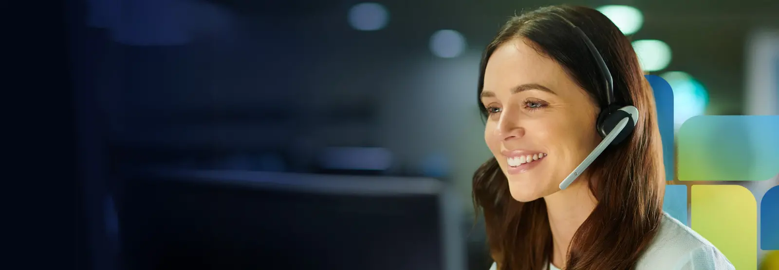Smiling woman wearing headset talking with provider about care coordination.