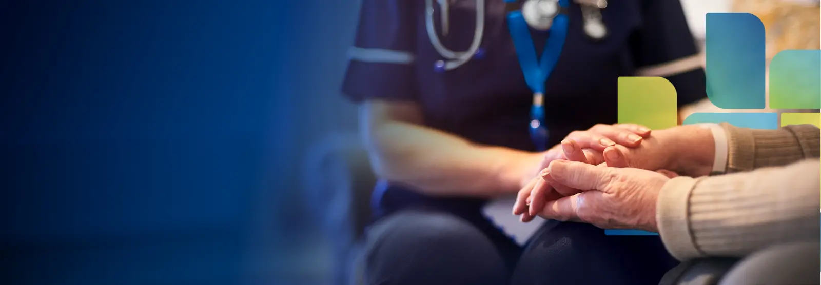 Medical professional holds hands with patient