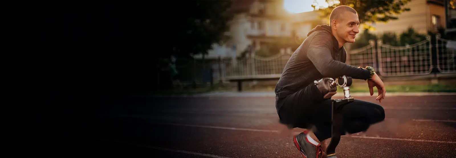 Man crouching down on a running track